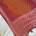 Rajvaari Bandhani Khaddi Georgette Saree – Rani Pink & Orange with Traditional Zari Weave